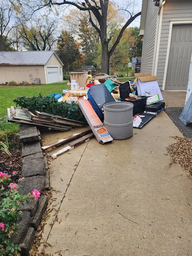 Dumpster being loaded with debris for Commercial Dumpster Rental in Englewood Cliffs